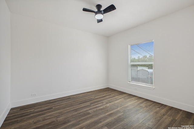 spare room featuring ceiling fan and dark hardwood / wood-style floors