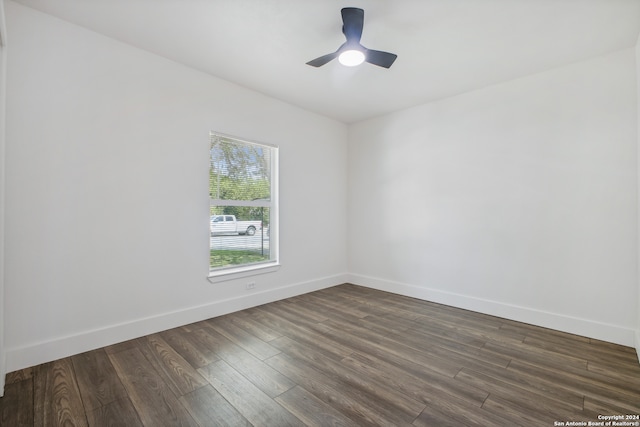 spare room with ceiling fan and dark hardwood / wood-style flooring