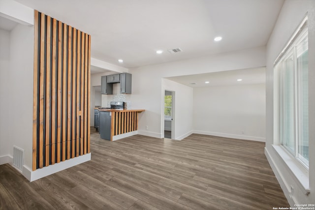 unfurnished living room with dark wood-type flooring