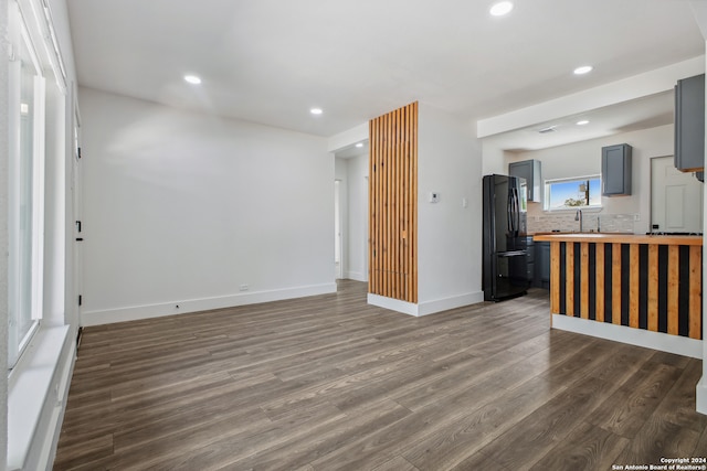 unfurnished living room with dark hardwood / wood-style flooring