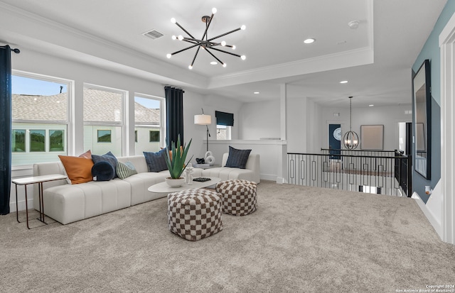 living room featuring a notable chandelier, a tray ceiling, light colored carpet, and crown molding