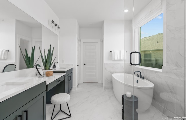 bathroom featuring vanity, tile walls, and a tub to relax in