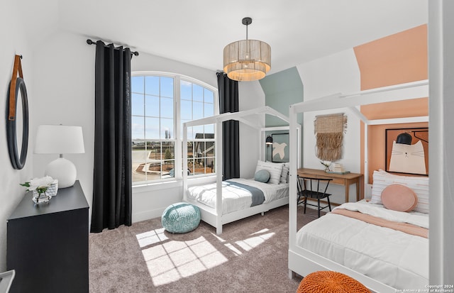 carpeted bedroom featuring a notable chandelier