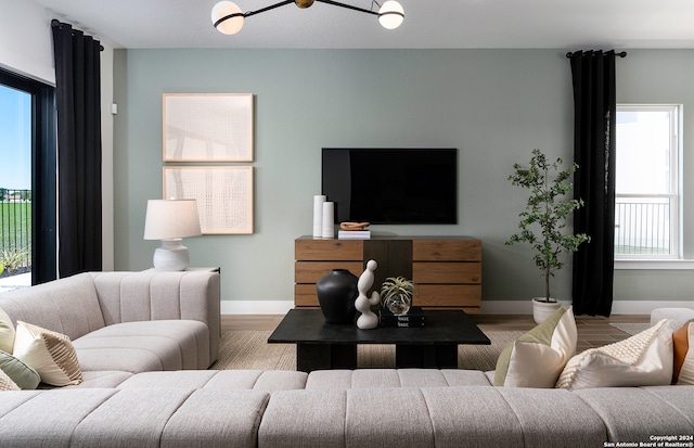 living room with light wood-type flooring and a healthy amount of sunlight