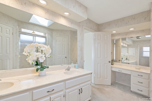 bathroom featuring vanity and a skylight