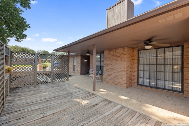 wooden terrace featuring a patio and ceiling fan