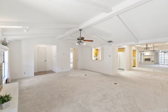 unfurnished living room with ceiling fan with notable chandelier, a fireplace, a textured ceiling, vaulted ceiling with beams, and light carpet