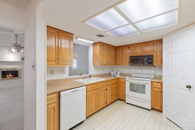 kitchen with white appliances, sink, and ceiling fan