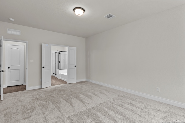 unfurnished bedroom with light colored carpet