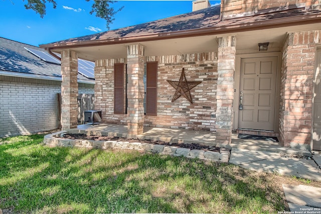 property entrance with a yard