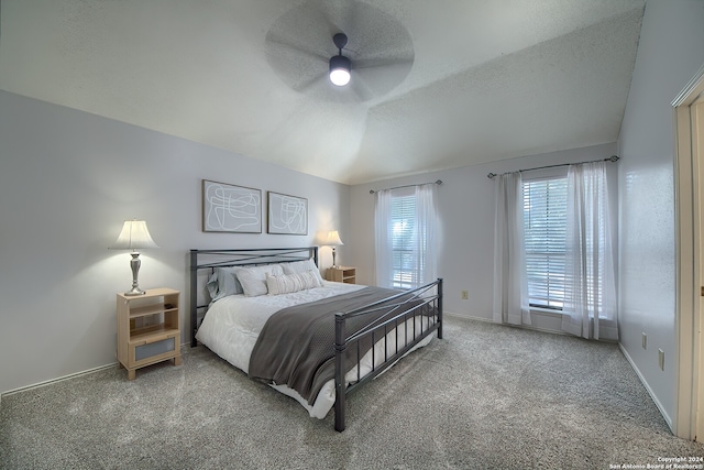 bedroom with ceiling fan, lofted ceiling, and carpet