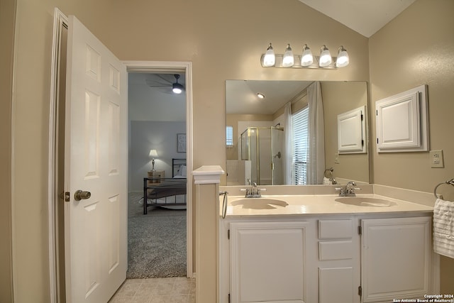 bathroom with ceiling fan, vanity, tile patterned flooring, an enclosed shower, and vaulted ceiling