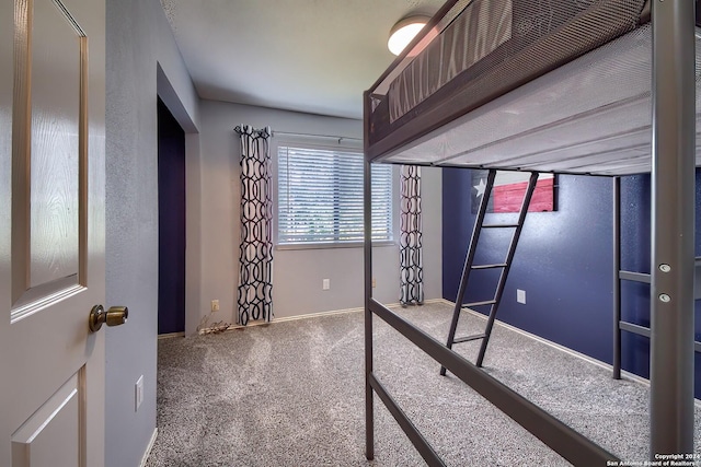 unfurnished bedroom with baseboards and carpet