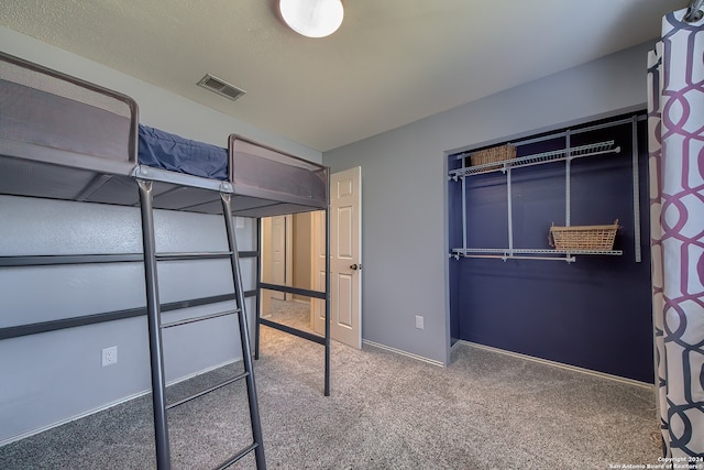 unfurnished bedroom featuring carpet and a closet