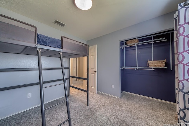 unfurnished bedroom featuring visible vents, baseboards, and carpet