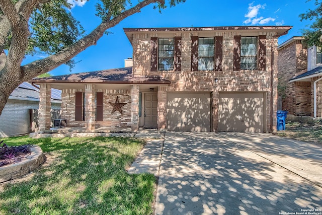 view of front of property with a front yard and a garage