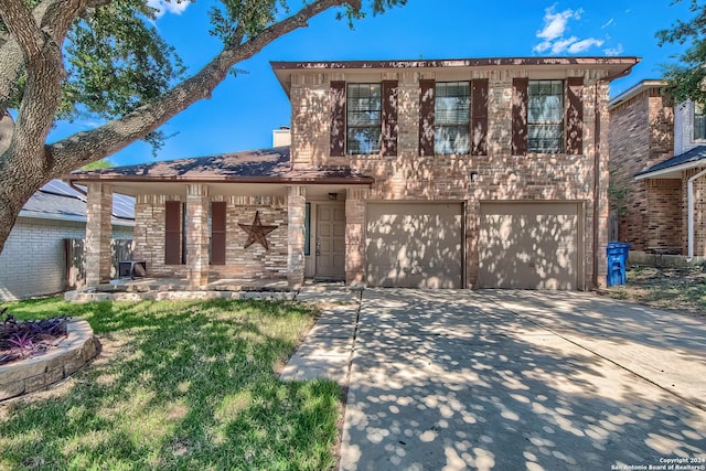traditional home featuring a garage and driveway