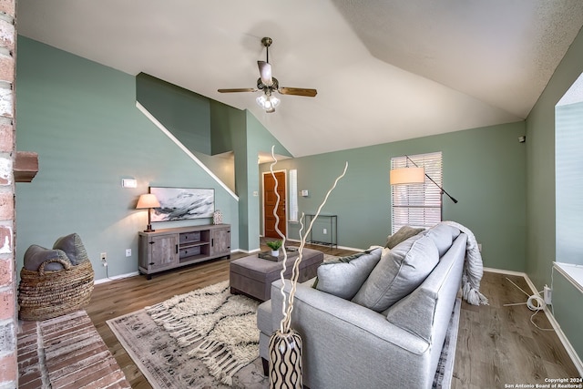 living room featuring wood-type flooring, lofted ceiling, and ceiling fan