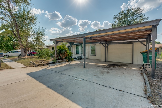 view of front of house with a garage and a carport