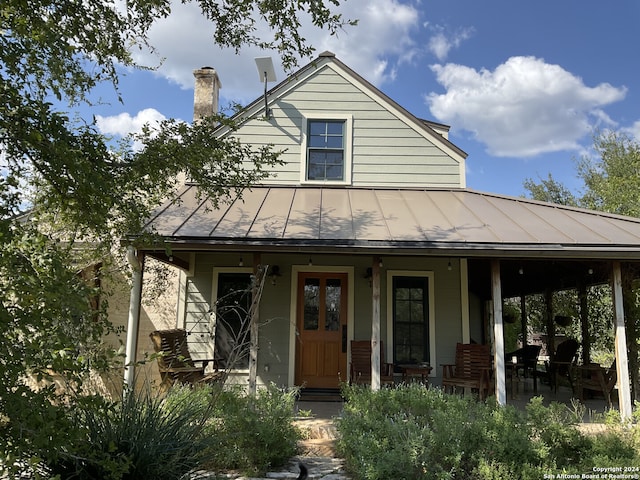 farmhouse featuring covered porch