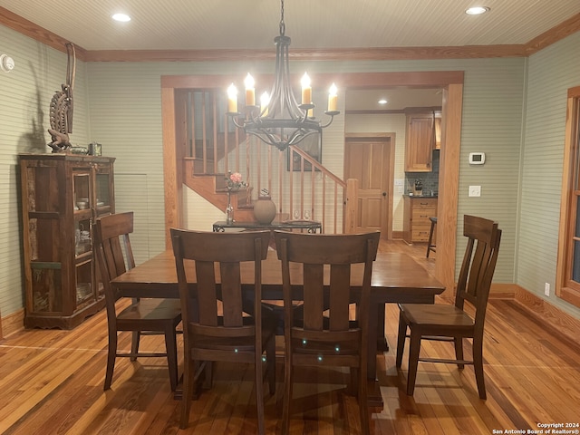 dining space with wood-type flooring and a chandelier