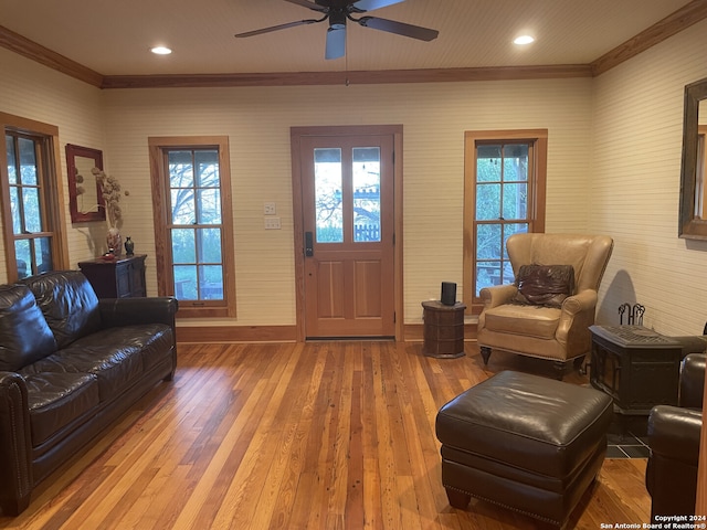 living room with ceiling fan, ornamental molding, and hardwood / wood-style floors