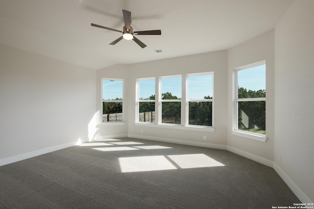 carpeted empty room with ceiling fan and a healthy amount of sunlight