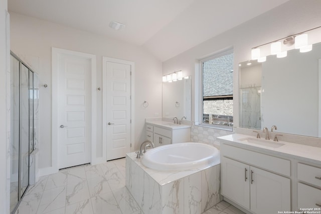 bathroom featuring plus walk in shower, vanity, and vaulted ceiling