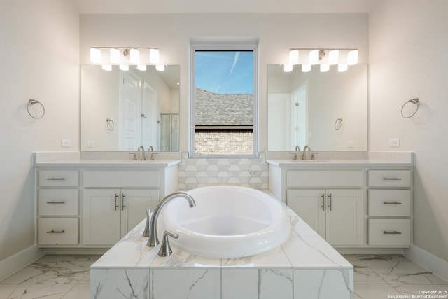 bathroom with a relaxing tiled tub and vanity