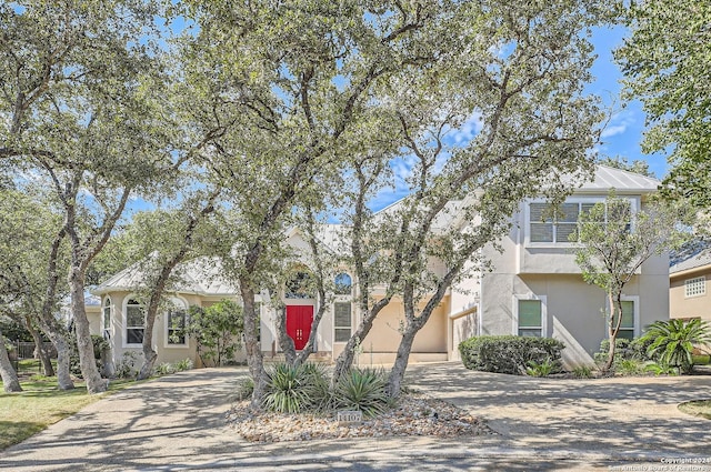 view of front facade featuring concrete driveway and stucco siding