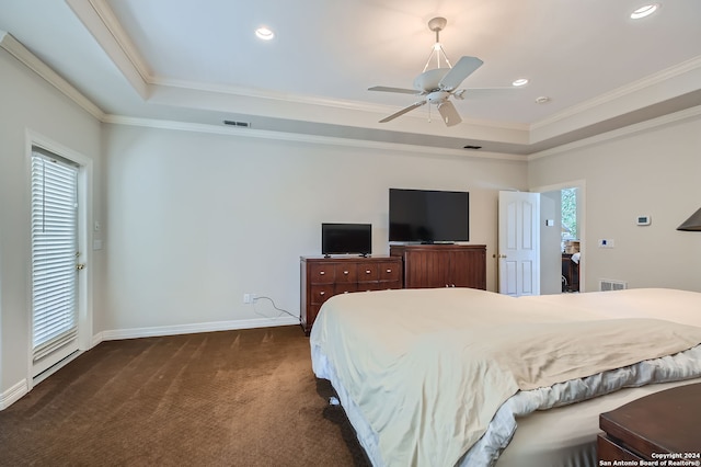 bedroom with ornamental molding, dark carpet, and ceiling fan