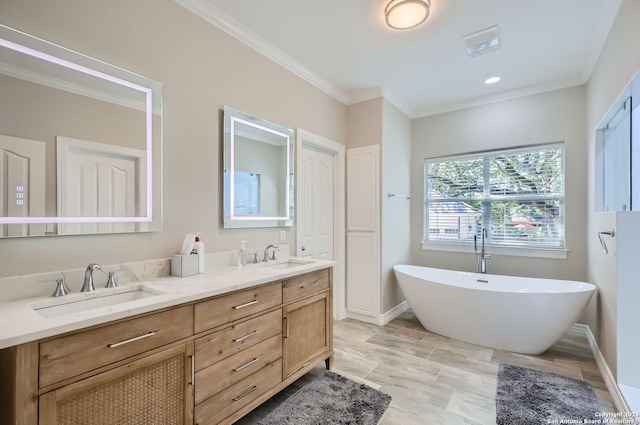 bathroom with vanity, ornamental molding, and a bath