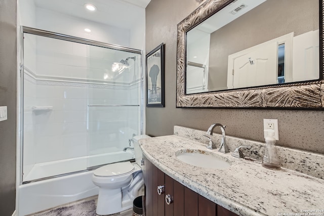 full bathroom featuring toilet, vanity, and combined bath / shower with glass door