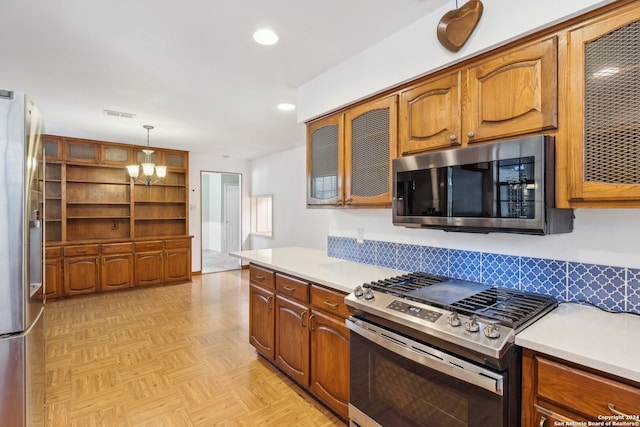 kitchen with hanging light fixtures, appliances with stainless steel finishes, light parquet floors, an inviting chandelier, and decorative backsplash