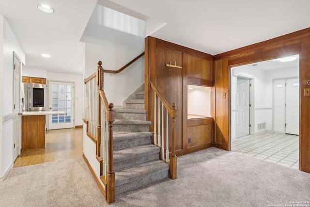 stairway featuring carpet floors