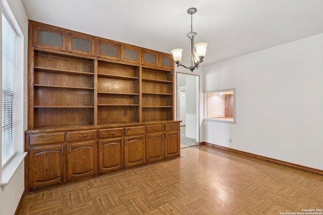 interior space featuring a notable chandelier and light parquet flooring