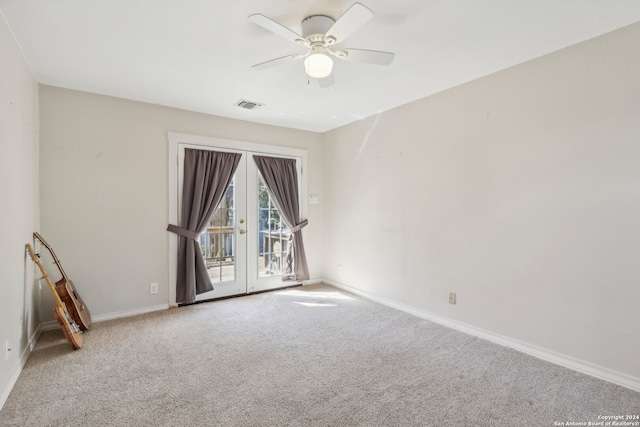 unfurnished room featuring french doors, carpet, and ceiling fan