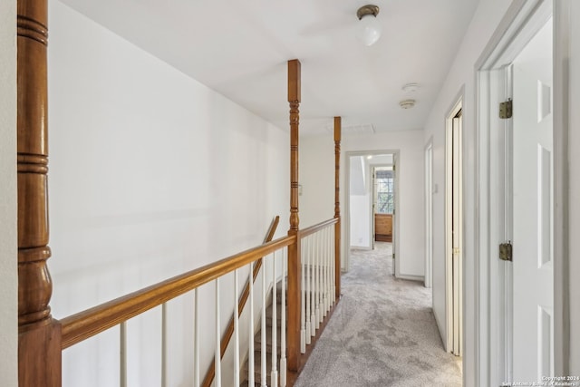 hallway featuring light colored carpet