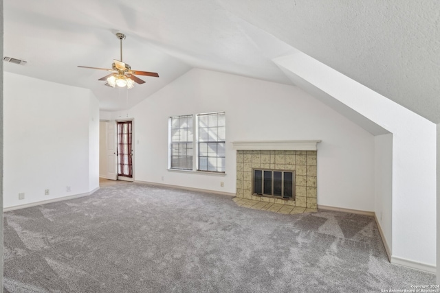 unfurnished living room featuring lofted ceiling, carpet floors, a fireplace, and ceiling fan