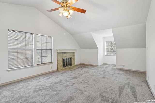 unfurnished living room with lofted ceiling, a healthy amount of sunlight, ceiling fan, and light colored carpet