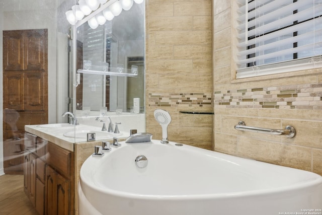 bathroom featuring vanity and tile walls