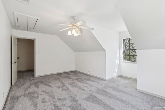 bonus room with ceiling fan, light carpet, and lofted ceiling