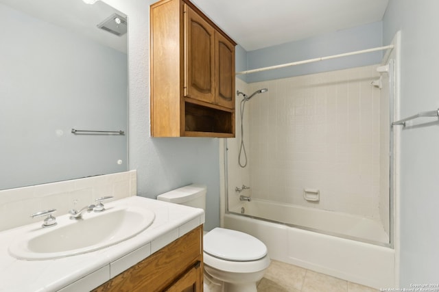 full bathroom featuring tile patterned flooring, tiled shower / bath, vanity, and toilet