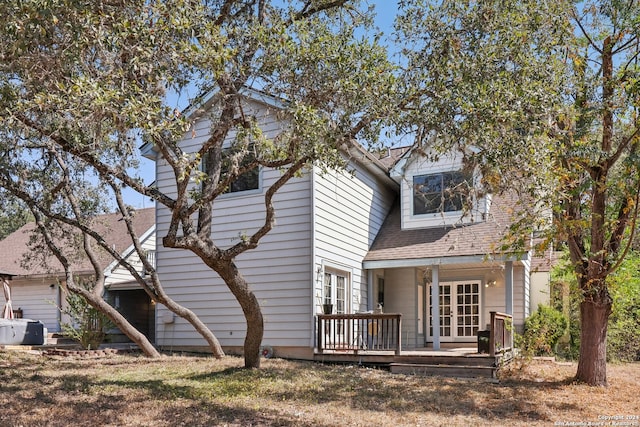 back of property with a deck and french doors