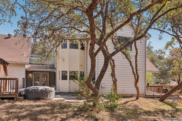 back of house featuring a wooden deck