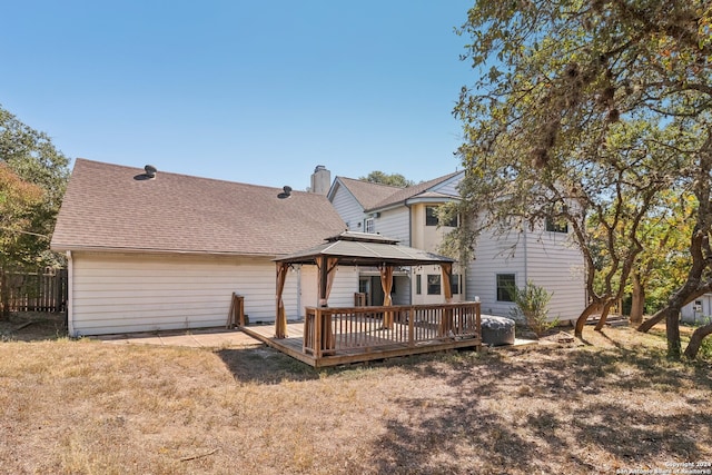 back of property featuring a gazebo and a wooden deck