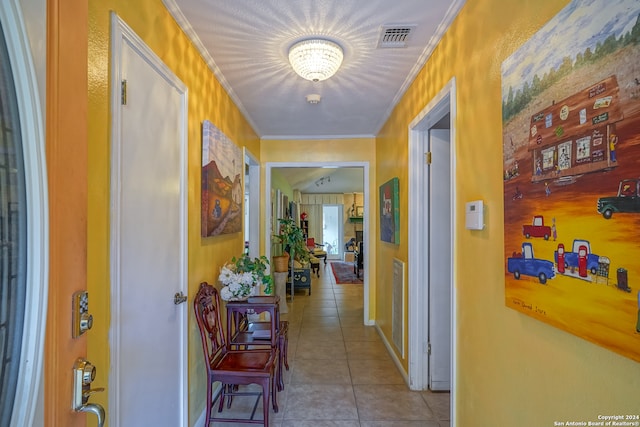 corridor with light tile patterned floors and crown molding