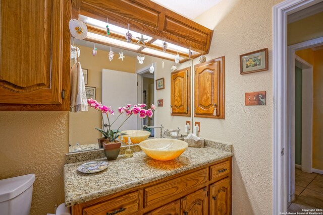 bathroom with tile patterned floors, vanity, and toilet