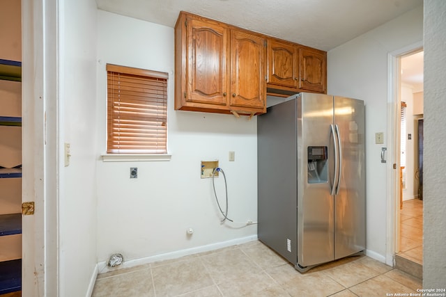 washroom featuring cabinets, washer hookup, electric dryer hookup, gas dryer hookup, and light tile patterned flooring