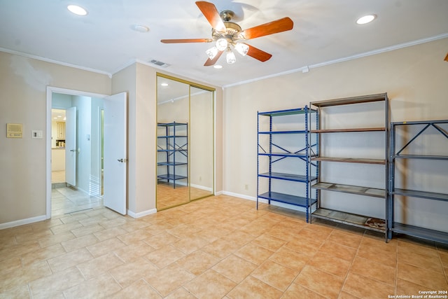 unfurnished room with ceiling fan and crown molding